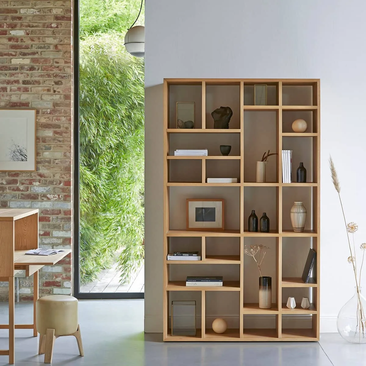 Scandinavian bookshelf with minimalist design, featuring clean lines and natural wood finish. Ideal for stylish and functional storage in modern and minimalist interiors