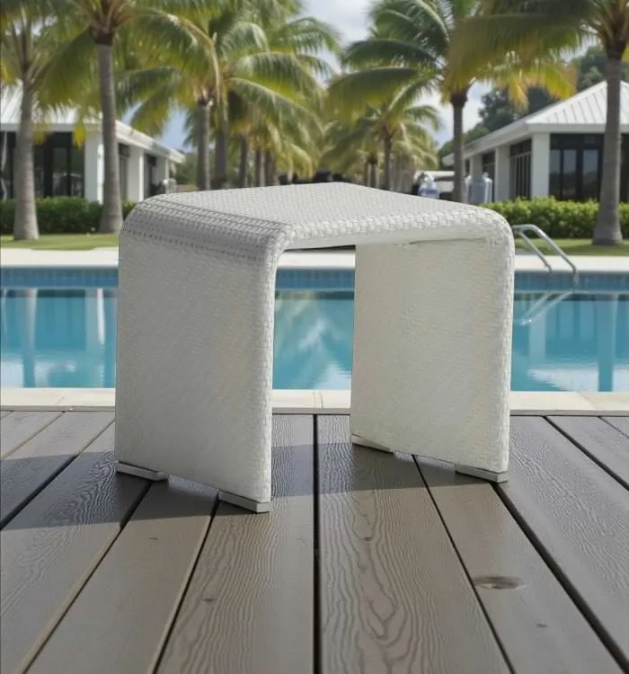Modern outdoor wicker side table on deck near swimming pool